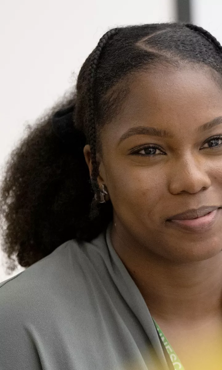 A Black female IOPC colleague smiles whilst speaking to a White male IOPC colleague